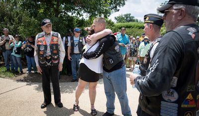 Legionnaire Charles Webb hugs Gold Star Mother Barbara Bilbrey, center, while World War II veteran Bruce Heilman, and Phil Perlman, left and right, join Legion members to lay a wreath at the Civil War Unknown Monument during the American Legion Riders Run To The Thunder in Washington, D.C., on Saturday, May 26, 2018. (Photo by Cheryl Diaz Meyer / The American Legion)