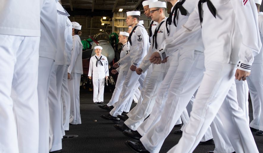 U.S. Navy Electricians Mate 1st Class Michael Feola, center, from Chatanooga, Tennessee, orders Sailors to march forward during a dress white uniform inspection in the hangar bay aboard the aircraft carrier USS John C. Stennis (CVN 74) in the Atlantic Ocean, May 10, 2019. The John C. Stennis is operating in the U.S. 2nd Fleet in support of naval operations to maintain maritime stability and security in the Atlantic and Arctic in order to ensure access, deter aggression and defend U.S., allied and partner interests. (U.S. Navy photo by Mass Communication Specialist Seaman Jarrod A. Schad)