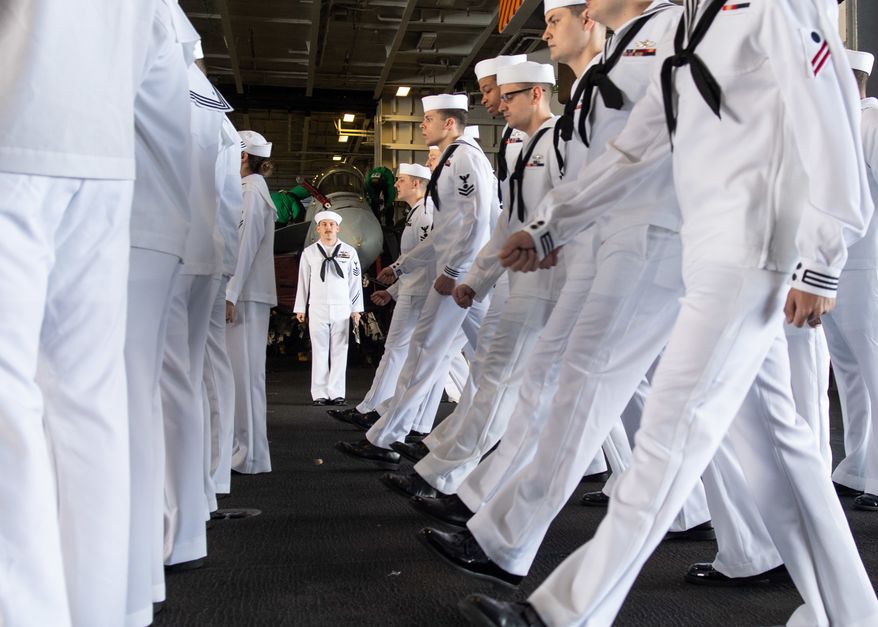 U.S. Navy Electricians Mate 1st Class Michael Feola, center, from Chatanooga, Tennessee, orders Sailors to march forward during a dress white uniform inspection in the hangar bay aboard the aircraft carrier USS John C. Stennis (CVN 74) in the Atlantic Ocean, May 10, 2019. The John C. Stennis is operating in the U.S. 2nd Fleet in support of naval operations to maintain maritime stability and security in the Atlantic and Arctic in order to ensure access, deter aggression and defend U.S., allied and partner interests. (U.S. Navy photo by Mass Communication Specialist Seaman Jarrod A. Schad)