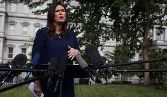 White House press secretary Sarah Sanders talks with reporters outside the White House, Wednesday, May 22, 2019, in Washington. (AP Photo/Evan Vucci)