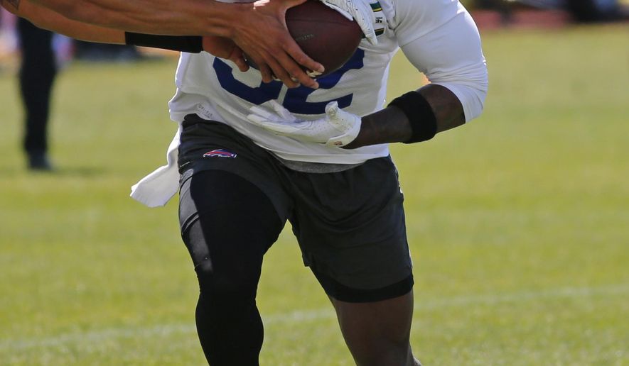 Buffalo Bills running back Senorise Perry (32) gets a handoff during an NFL football organized team activity Tuesday, May 21, 2019, in Orchard Park N.Y. (AP Photo/Jeffrey T. Barnes)