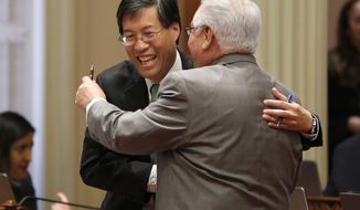 State Sen. Richard Pan, D-Sacramento, left, receives congratulations from Southern California Democratic state Sen. Bob Archuleta, right, after his measure to toughen the rules for vaccination exemptions was approve by the Senate, Wednesday, May 22, 2019, in Sacramento, Calif. The bill, SB276, gives state public health officials instead of local doctors the power to decide which children can skip their shots before attending school. (AP Photo/Rich Pedroncelli)