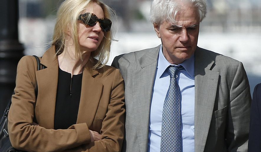 Marcia, left, and Gregory Abbott leave federal court, Wednesday, May 22, 2019, in Boston, where they pleaded guilty to charges in a nationwide college admissions bribery scandal. (AP Photo/Michael Dwyer)