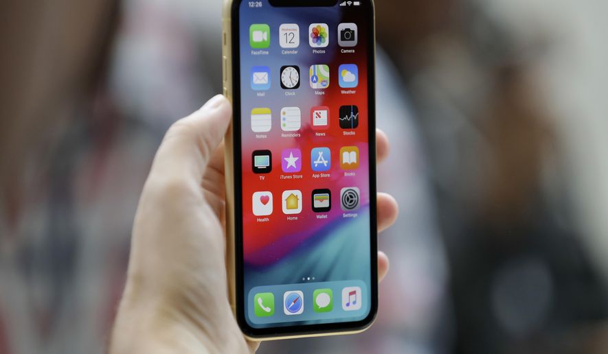 This Sept. 12, 2018, file photo shows an Apple iPhone XR on display at the Steve Jobs Theater after an event to announce new products, in Cupertino, Calif. (AP Photo/Marcio Jose Sanchez, File)