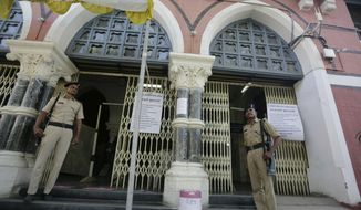 Indian policemen stand guard outside a vote counting center in Ahmadabad, India, Wednesday, May 22, 2019. India&#39;s Election Commission has rejected opposition fears of possible tampering of electronic voting machines ahead of Thursday&#39;s vote-counting to determine the outcome of the country&#39;s mammoth national elections. Authorities on Wednesday tightened security at counting centers where the electronic voting machines have been kept in strong rooms across the country. (AP Photo/Ajit Solanki)