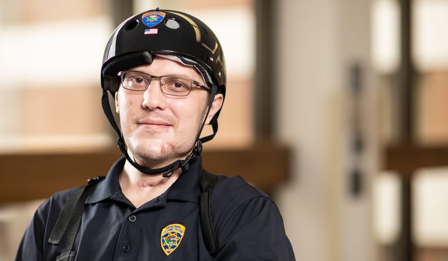 In this image provided by University of Utah Health, Montana Highway Patrol Trooper Wade Palmer poses at University of Utah Health, Wednesday, May 22, 2019, in Salt Lake City. Palmer returned home to Montana on Wednesday to continue his recovery, just over two months after he was shot in the head, face and neck while investigating a fatal shooting. Doctors said Wade Palmer suffered a traumatic brain injury and is unable to speak but seems to understand what is being said. (University of Utah Health via AP)