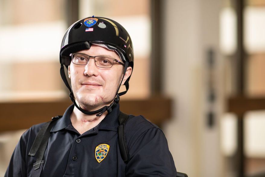 In this image provided by University of Utah Health, Montana Highway Patrol Trooper Wade Palmer poses at University of Utah Health, Wednesday, May 22, 2019, in Salt Lake City. Palmer returned home to Montana on Wednesday to continue his recovery, just over two months after he was shot in the head, face and neck while investigating a fatal shooting. Doctors said Wade Palmer suffered a traumatic brain injury and is unable to speak but seems to understand what is being said. (University of Utah Health via AP)