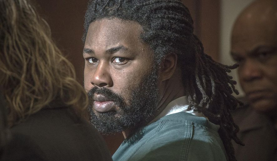 FILE - In this Nov. 14, 2014 file photo Jesse Matthew Jr. looks toward the gallery while appearing in court in Fairfax, Va. Matthew, who abducted and killed two Virginia college students five years apart, was transferred to a new prison this week so he can receive medical treatment for cancer. He is serving multiple life sentences for the 2009 murder of Virginia Tech student Morgan Harrington and the 2014 murder of University of Virginia student Hannah Graham. He pleaded guilty in 2016 to both killings. A spokeswoman for the Virginia Department of Corrections confirmed that Matthew was transferred Monday, May 20, 2019, from the Red Onion State Prison in Wise County to Sussex I State Prison. (Bill O'Leary/The Washington Post via AP, Pool, File)