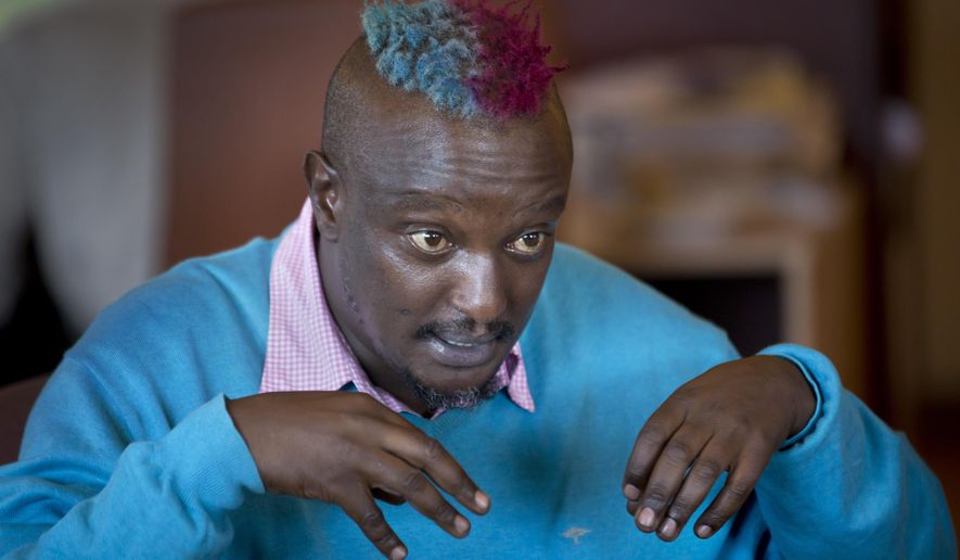 FILE - In this Wednesday, Jan. 22, 2014 file photo, prize-winning Kenyan author Binyavanga Wainaina talks during a television interview in Nairobi, Kenya. The chairman of the Kwani Trust which Wainaina founded said Wednesday, May 22, 2019 that the author and LGBT activist died Tuesday night in Nairobi. (AP Photo/Ben Curtis, File)