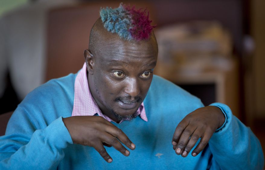 FILE - In this Wednesday, Jan. 22, 2014 file photo, prize-winning Kenyan author Binyavanga Wainaina talks during a television interview in Nairobi, Kenya. The chairman of the Kwani Trust which Wainaina founded said Wednesday, May 22, 2019 that the author and LGBT activist died Tuesday night in Nairobi. (AP Photo/Ben Curtis, File)