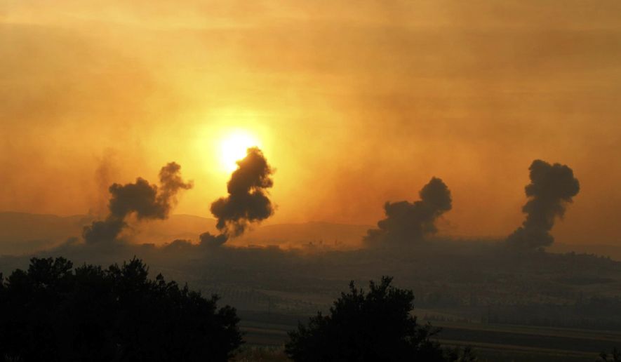 This photo provided Tuesday, May 21, 2019 by the Syrian Civil Defense group known as the White Helmets, shows smoke rising after Syrian government forces targeted the town of al-Habeet, in Idlib province, Syria. Syrian activists and a rebel spokesman said Wednesday, that opposition fighters have recaptured Kfar Nabuda, a village at the edge of the last rebel stronghold in northwestern Syria. (Syrian Civil Defense White Helmets via AP)