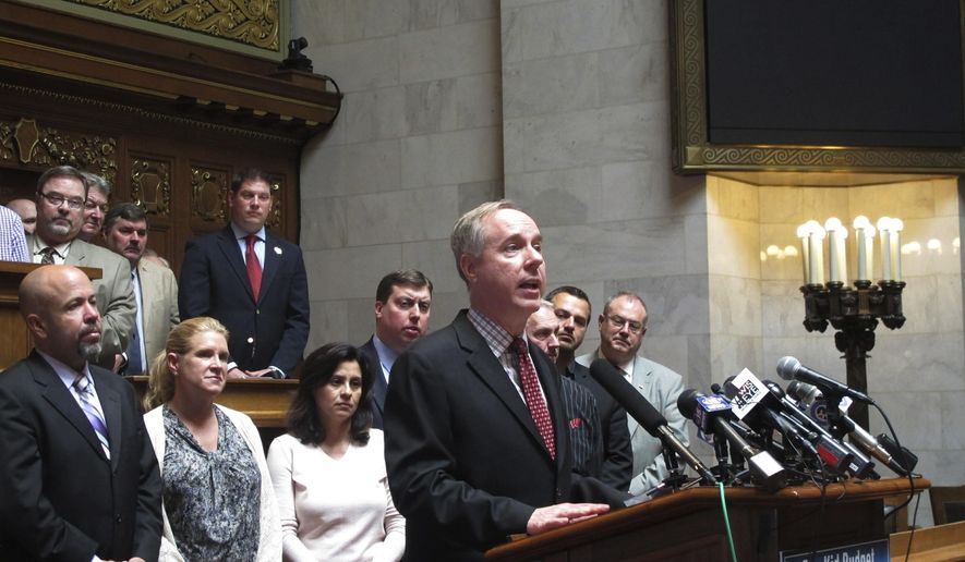 Wisconsin Assembly Speaker Robin Vos, at podium, surrounded by fellow Republican lawmakers, unveils a Republican K-12 funding plan that calls for increasing spending less than half as much as Democratic Gov. Tony Evers wanted on Wednesday, May 22, 2019, at the Capitol in Madison, Wisconsin. (AP Photo/Scott Bauer)