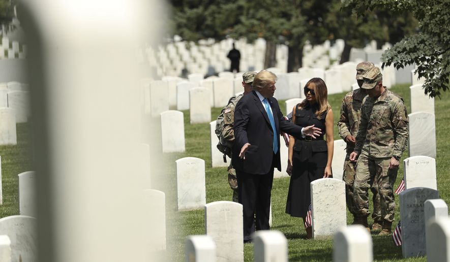 President Donald Trump and first lady Melania Trump visit Arlington National Cemetery for the annual Flags In ceremony ahead of Memorial Day Thursday, May 23, 2019, in Arlington, Va. (AP Photo/Andrew Harnik)