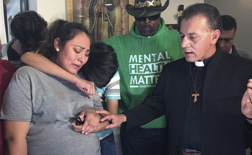 In this Tuesday, May 21, 2019 photo provided by WBEZ Radio is Adilene Marquina, left, as she sobs after announcing she will be seeking sanctuary inside Faith, Life and Hope Mission church on Chicago's Southwest Side. Hugging her is her son, Johan as Rev. Jose Landaverde, right, comforts her. A pregnant Marquina is seeking asylum in a Chicago church after she says she received a deportation order and must leave the U.S. WBEZ radio reported Tuesday that Adilene Marquina has a high-risk pregnancy and is afraid to travel back to Mexico. She is now staying at the Faith, Life and Hope Mission because U.S. immigration policy is to not make arrests in places of worship. Marquina has until Thursday to leave the U.S. Her baby is due July 23. (María Ines Zamudio/WBEZ Radio via AP)