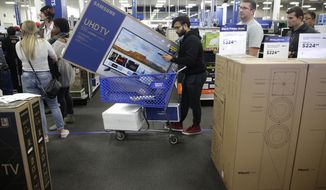 FILE- In this Nov. 22, 2018, file photo people wait in line to buy televisions as they shop during an early Black Friday sale at a Best Buy store on Thanksgiving Day in Overland Park, Kan. Best Buy Co., Inc. reports financial results Thursday, May 23, 2019. (AP Photo/Charlie Riedel, File)