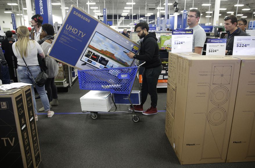 FILE- In this Nov. 22, 2018, file photo people wait in line to buy televisions as they shop during an early Black Friday sale at a Best Buy store on Thanksgiving Day in Overland Park, Kan. Best Buy Co., Inc. reports financial results Thursday, May 23, 2019. (AP Photo/Charlie Riedel, File)