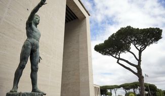 A bronze sculpture by Italo Griselli, known under the Fascist regime as &amp;quot;Saluto Fascista&amp;quot; (Fascist Salute) and after the war renamed Genio dello Sport (Genius of Sport), stands at the entrance of a fascist architecture building in the EUR neighborhood, in Rome, Monday, May 6, 2019. Mussolini transformed Rome’s urban landscape with grand construction projects like EUR, a new city district that was originally designed as celebration of fascism for a world fair in 1942. The fair was canceled due to WWII and construction was halted but resumed after the war. (AP Photo/Andrew Medichini)
