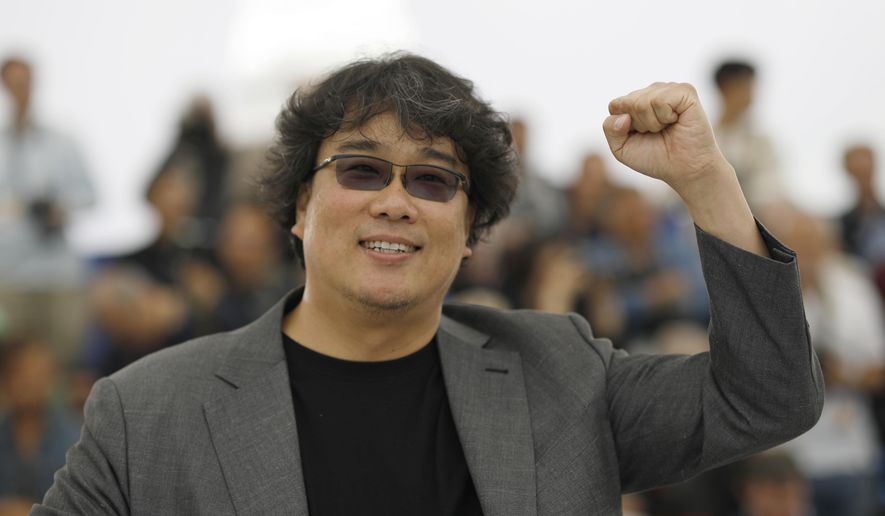 Director Bong Joon-ho poses for photographers at the photo call for the film 'Parasite' at the 72nd international film festival, Cannes, southern France, Wednesday, May 22, 2019. (AP Photo/Petros Giannakouris)