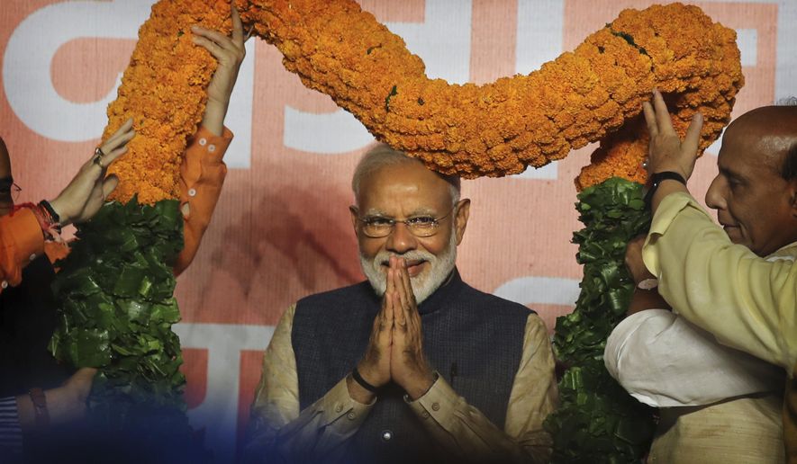 Indian Prime Minister Narendra Modi receives a giant floral garland from party leaders at their headquarters in New Delhi, India, Thursday, May 23, 2019. Indian Prime Minister Narendra Modi&#x27;s party claimed it had won reelection with a commanding lead in Thursday&#x27;s vote count, while the stock market soared in anticipation of another five-year term for the pro-business Hindu nationalist leader. (AP Photo/Manish Swarup)