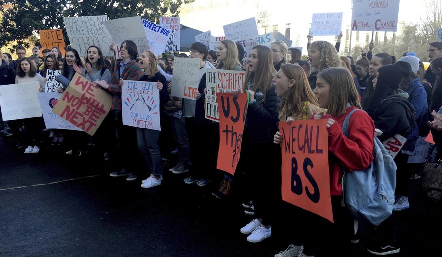 FILE - In this March 5, 2018, file photo, high school students from lake Oswego, Ore., hold a rally for gun control on the steps of the Oregon State Capitol. Democrats in the Oregon Legislature have pushed through a gun-control bill after they sacrificed a different one in a deal with minority Republicans to get an education tax bill over the finish line. The bill that passed the Senate Thursday, May 23, 2019, is aimed at keeping guns out of the hands of domestic abusers and stalkers. (AP Photo/Andrew Selsky, File)