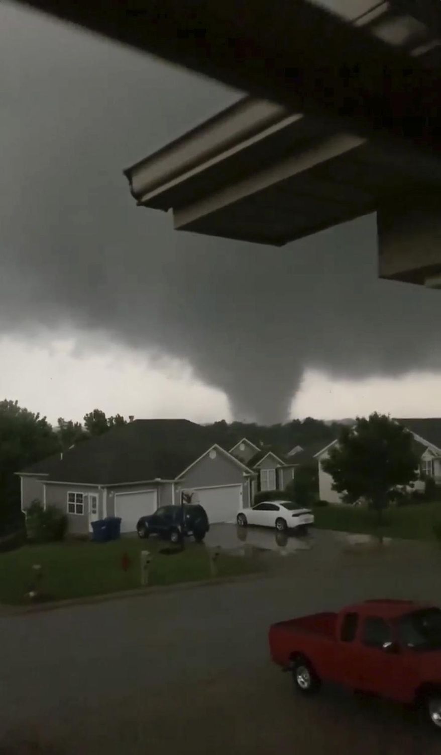 This still image taken from video provided by Chris Higgins shows a tornado, Wednesday, May 22, 2019, in Carl Junction, Mo. The tornado caused some damage in the town of Carl Junction, about 4 miles (6.44 kilometers) north of the Joplin airport. (Chris Higgins via AP)