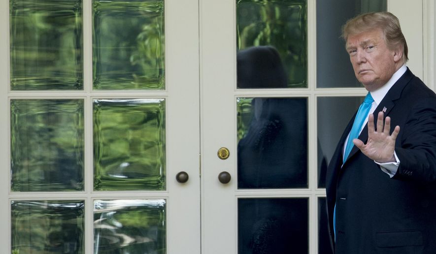 President Donald Trump waves as he walks towards the Oval Office in Washington, Thursday, May 23, 2019, after visiting the annual Flags In ceremony at Arlington National Cemetery. (AP Photo/Andrew Harnik)