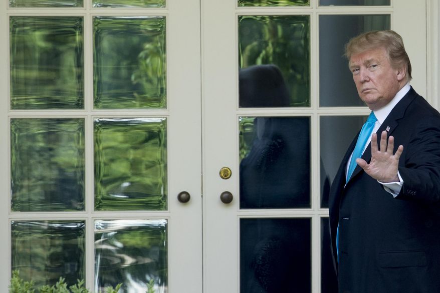 President Donald Trump waves as he walks towards the Oval Office in Washington, Thursday, May 23, 2019, after visiting the annual Flags In ceremony at Arlington National Cemetery. (AP Photo/Andrew Harnik)