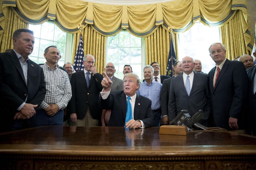 President Donald Trump, accompanied by Rep. Mike Conaway, R-Texas, fourth from left, Agriculture Secretary Sonny Perdue, fourth from right, and farmers and ranchers, speaks in the Oval Office of the White House, Thursday, May 23, 2019, in Washington. (AP Photo/Andrew Harnik)