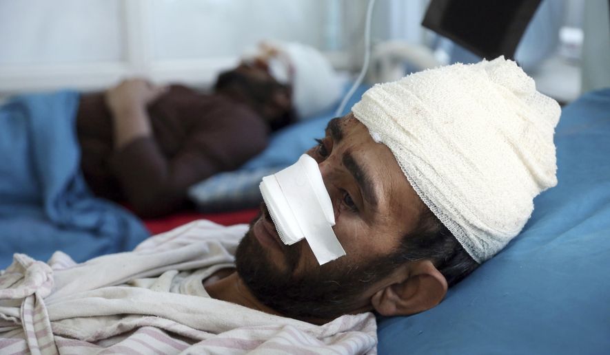 A wounded man receives treatment in a hospital after a bomb explosion during Friday prayer on the outskirts of Kabul, Afghanistan, Friday, May 24, 2019. According to Kabul police chief's spokesman, Basir Mujahid, the bomb was concealed in the microphone used to deliver the sermon. The prayer leader, Maulvi Samiullah Rayan, was the intended target, the spokesman added. (AP Photo/Rahmat Gul)