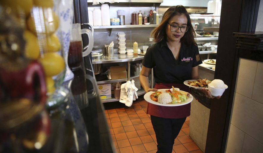 ADVANCE FOR USE IN WEEKEND EDITIONS, SATURDAY, MAY 25, 2019, 12:01 a.m. PDT AND THEREAFTER  In this Thursday, May 16, 2019 photo, Lita Harris runs food to customers during lunch at Archi&#39;s Thai Bistro in Las Vegas. From Vietnamese churches to Thai restaurants and even on TV, signs show that Asian-Americans are the fastest-growing racial or ethnic group in the Las Vegas area. (Erik Verduzco/Las Vegas Review-Journal via AP)