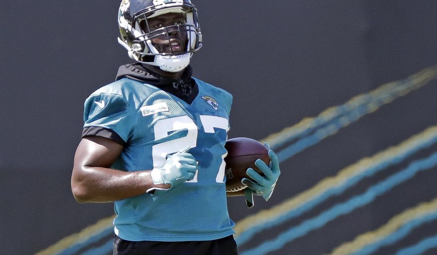 Jacksonville Jaguars running back Leonard Fournette (27) carries the ball during an NFL football practice, Tuesday, May 21, 2019, in Jacksonville, Fla. (AP Photo/John Raoux)