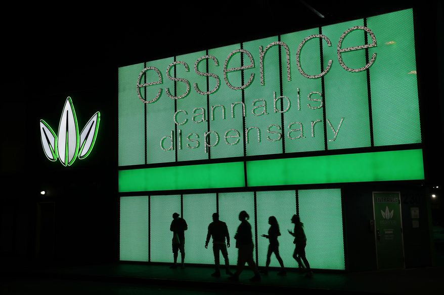 FILE - This April 16, 2018, file photo shows the Essence cannabis dispensary in Las Vegas. A Nevada judge is being asked to freeze the awarding of new dispensary licenses in the state's booming recreational marijuana sales market. Businesses that lost bids for new licenses last year are challenging the criteria and personnel the state used to award the potentially lucrative permits last year. AP Photo/John Locher, File)