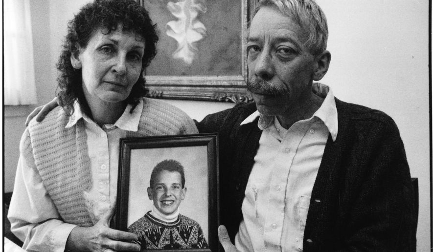 In this Jan. 7, 1992 photo, Esther and Allan Chereck, parents of slain David Chereck, hold a photo of their son during an interview at their home in Skokie, Ill. on Jan. 7, 1992. Eduardo Contreras, Robert Serritella was found guilty Thursday, May 23, 2019 of first-degree murder in the 1992 death of 15-year-old David Chereck. Serritella, 76, of Park Ridge, was charged in 2014 in the decades-old cold case. Chereck was found strangled with his own scarf in a Morton Grove forest preserve. (Eduardo Contreras/Chicago Tribune via AP)