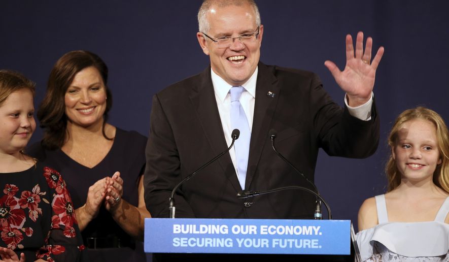 In this May 19, 2019, file photo, Australian Prime Minister Scott Morrison speaks to party supporters flanked by his wife, Jenny, second from left, and daughters Lily, right, and Abbey, after his opponent concedes in the federal election in Sydney, Australia. Australia’s newly reelected administration says its promise to slash income taxes might be delivered late but won’t be broken as the government hopes to stimulate consumer spending and revive a flagging economy. (AP Photo/Rick Rycroft, File)