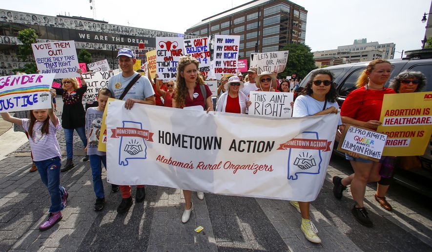 In this May 19, 2019, photo, protesters for women's rights march to the Alabama Capitol to protest a law passed last week making abortion a felony in nearly all cases with no exceptions for cases of rape or incest in Montgomery, Ala. Members of both parties say a flood of laws banning abortions in Republican-run states has handed Democrats a daunting weapon for next years elections. They say the restrictions will help Democrats paint the GOP as extreme and woo centrist voters who could decide tight House and Senate races. (AP Photo/Butch Dill) **FILE**