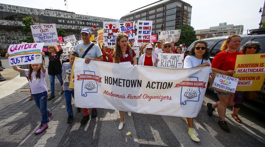 In this May 19, 2019, photo, protesters for women's rights march to the Alabama Capitol to protest a law passed last week making abortion a felony in nearly all cases with no exceptions for cases of rape or incest in Montgomery, Ala. Members of both parties say a flood of laws banning abortions in Republican-run states has handed Democrats a daunting weapon for next years elections. They say the restrictions will help Democrats paint the GOP as extreme and woo centrist voters who could decide tight House and Senate races. (AP Photo/Butch Dill) **FILE**