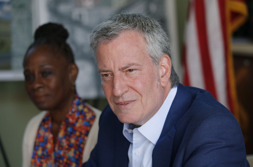 Democratic presidential candidate New York Mayor Bill de Blasio, right, and his wife Chirlane McCray speak with veterans and military families at Veterans Village II, Saturday, May 25, 2019, in Las Vegas. (AP Photo/John Locher)