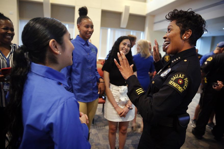 In this Tuesday, May 21, 2019 photo, Dallas Police Chief U. Renee Hall, right, visits with Youth Commission representatives, from left, Judith Gonzalez (back to camera), Francesca Jennings (in blue, facing camera) and Fernanda Aguero, after the launch of DPD to YOU(TH) Summer Jobs Program, a summer jobs program for teens from some of Dallas' most underserved communities at Dallas Police Headquarters. Between 43-50 students will intern in police substations in their communities this summer. Volunteers will mentor the students in the program also involving businesses, government agencies and nonprofits. (Tom Fox/The Dallas Morning News via AP)