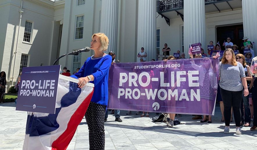 In this May 22, 2019, photo, Beck Gerritson, president of Eagle Forum of Alabama, speaks at an anti-abortion rally outside the Capitol in Montgomery, Ala. Members of both parties say a flood of laws banning abortions in Republican-run states has handed Democrats a daunting weapon for next year’s elections. They say the restrictions will help Democrats paint the GOP as extreme and woo centrist voters who could decide tight House and Senate races. (AP Photo/Kim Chandler)