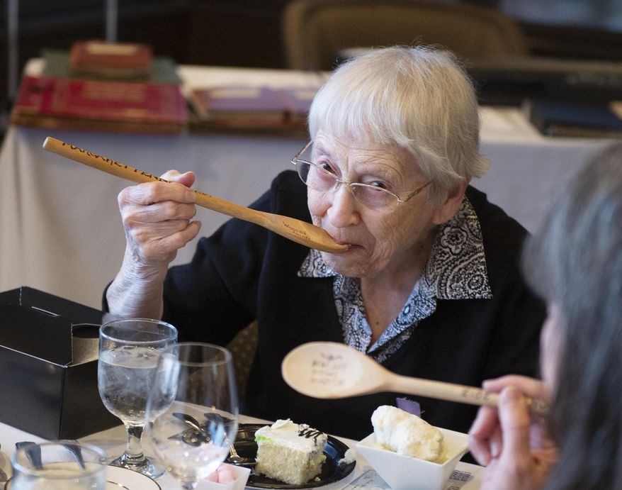 Margaret Penney, the person who has the longest membership of the Wooden Spoons, an all women's social club started by Louise Pound in 1919, takes a bite of ice cream with her wooden spoon during its final gathering on Tuesday, May 14, 2019, at US Bank. Penney became a member in 1969. It was tradition in the past to eat meals with the wooden spoons. Although the tradition stopped, Penney takes one bite using her spoon during the final gathering. (Emily Haney/Lincoln Journal Star via AP)
