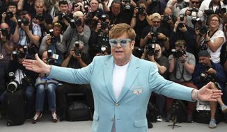 In this Thursday, May 16, 2019, file photo, singer Elton John poses for photographers at the photo call for the film &quot;Rocketman&quot; at the 72nd international film festival, Cannes, southern France. (Photo by Joel C Ryan/Invision/AP) ** FILE **