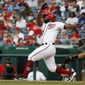 Washington Nationals&#39; Howie Kendrick, left, follows through as he hits a home run against the Miami Marlins in the second inning of a baseball game, Sunday, May 26, 2019, in Washington. (AP Photo/Jacquelyn Martin)