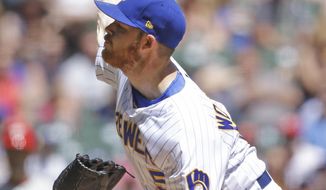 Milwaukee Brewers starting pitcher Brandon Woodruff throws to the Philadelphia Phillies during the first inning of a baseball game Sunday, May 26, 2019, in Milwaukee. (AP Photo/Jeffrey Phelps)