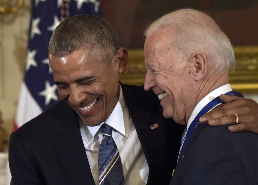 President Barack Obama laughs with Vice President Joe Biden during a ceremony in the State Dining Room of the White House in Washington, Thursday, Jan. 12, 2017. Obama presented Biden with the Presidential Medal of Freedom. (AP Photo/Susan Walsh)
