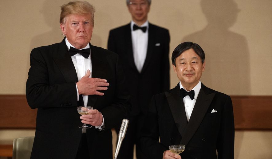 U.S. President Donald Trump and Japanese Emperor Naruhito listen to the national anthem during a State Banquet at the Imperial Palace, Monday, May 27, 2019, in Tokyo. (AP Photo/Evan Vucci)