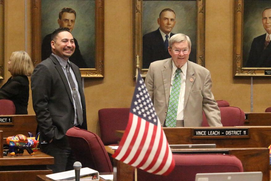 Democratic Sen. Martin Quezada and Republican Sen. Vince Leach talk during a break in budget votes at the Arizona state Capitol in Phoenix on Monday, May 27, 2019. The Legislature on Memorial Day broke an impasse that had prevented passage of a state budget for weeks. (AP Photo/Jonathan J. Cooper)