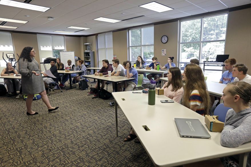 In this photo taken Tuesday, May 21, 2019, 11th grade students learn about the D-Day invasion at Normandy from social sciences teacher Kasey Turcol during an advanced placement history class at Crossroads FLEX school in Cary, N.C. Turcol has just 75 minutes to explain to her high school students the importance of D-Day - and if this wasn’t the 75th anniversary of the turning point in World War II, she wouldn’t devote that much time to it. (AP Photo/Gerry Broome) **FILE**