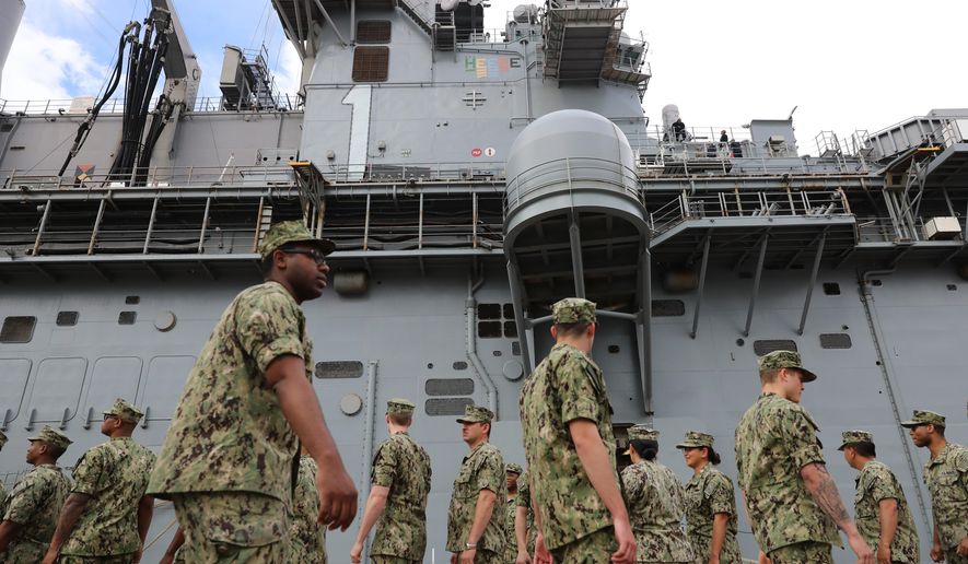U.S. troops gather on the USS Wasp where U.S. President Donald Trump will deliver Memorial Day remarks to the troops, at the U.S. Military Base in Yokosuka, south of Tokyo, Tuesday, May 28, 2019. (AP Photo/Eugene Hoshiko) **FILE**