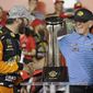 Martin Truex Jr., left, is congratulated by team owner Joe Gibbs in Victory Lane after winning the NASCAR Cup Series auto race at Charlotte Motor Speedway in Concord, N.C., Sunday, May 26, 2019. (AP Photo/Chuck Burton)