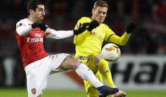 FILE - In this Thursday, Feb. 14, 2019 file photo Arsenal&#39;s Henrikh Mkhitaryan, left, duels for the ball with Bate&#39;s Aleksandar Filipovic during the Europa League round of 32 first leg soccer match between Bate and Arsenal at the Borisov-Arena in Borisov, Belarus. The choice of Baku as host of the Europa League final provided Arsenal with further grounds for discontent Tuesday when Mkhitaryan, one of the team&#39;s most talented players, pulled out of the game for political reasons. (AP Photo/Sergei Grits, File)
